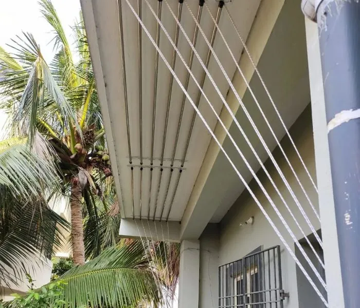 Ceiling-mounted stainless steel cloth drying hanger system for apartment balconies.