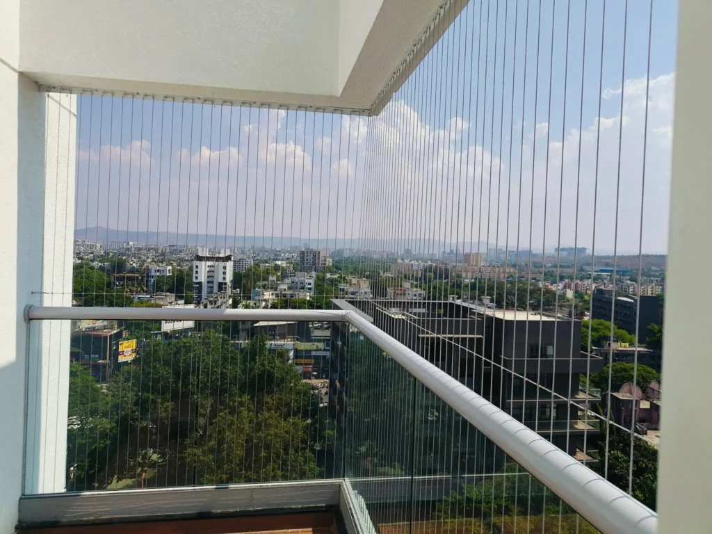 Comparison between bulky iron grills and sleek, modern invisible grills for home safety,Durable and transparent balcony safety grills in toli chowk